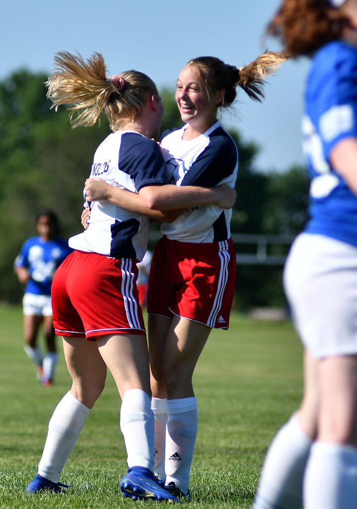 Jersey Reynolds, left, 14, runs up to congratulate fellow forward Landry Watson, 14